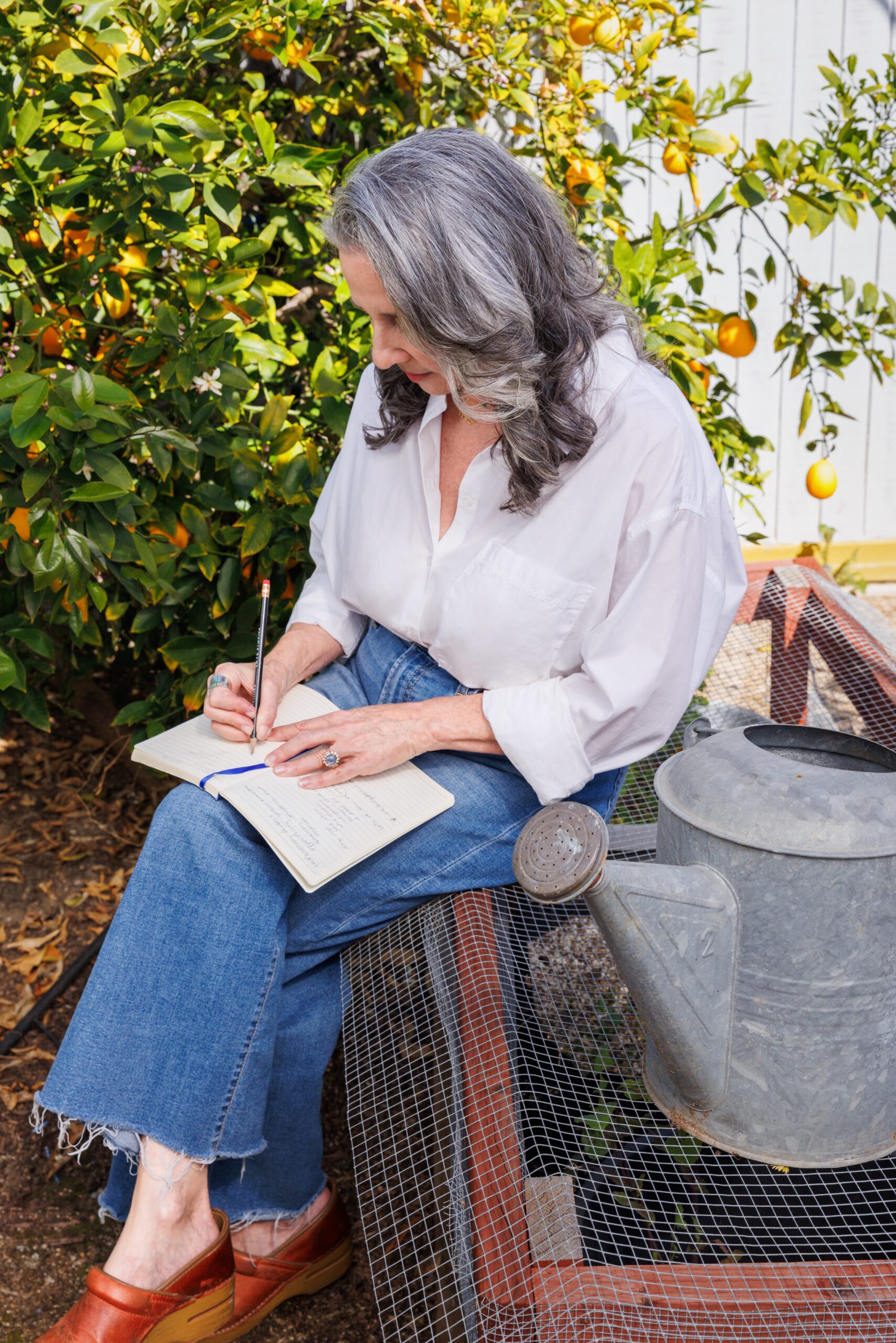 Dr. Suzanne writing outdoors